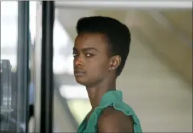  ?? RICHARD VOGEL — THE ASSOCIATED PRESS ?? Australian-South Sudanese model Adau Mornyang checks in through security for her court case at the Federal Courthouse in downtown Los Angeles on Monday.