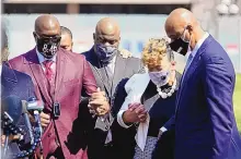  ?? JIM MONE/ASSOCIATED PRESS ?? Philonise Floyd, left, the brother of George Floyd, and other family members take part in a prayer vigil led by the Rev. Al Sharpton outside the Hennepin County Government Center on Tuesday.