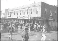  ?? (Courtesy Photo/Rogers Historical Museum) ?? A parade down First Street about 1940. Croxdale’s Grocery is on the corner of First and Elm streets. The building that housed Croxdales was one of the first masonry buildings in Rogers, The Commercial Hotel, built in 1885.