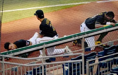  ?? Matt Freed/Post-Gazette ?? Pirates first baseman Phillip Evans, left, waits for help on the field Saturday after colliding with Gregory Polanco in the sixth inning at PNC Park. Evans was taken from the field on a stretcher.