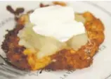  ??  ?? Francie Swidler and her mom, Pearl Swidler, (above) make latkes with applesauce and sour cream (below) for Hanukkah.