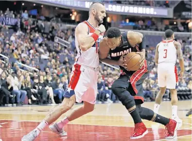  ?? ALEX BRANDON/AP ?? Heat center Hassan Whiteside works against Wizards center Marcin Gortat during the first half Tuesday in Washington, D.C. Miami has not had a win on the road since Jan. 29 in Dallas, with the away slump now at seven games.
