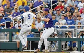  ?? MATT RYERSON / ASSOCIATED PRESS ?? Florida’s Dalton Guthrie (left) beats the throw to LSU first baseman Nick Coomes during Game 2 of the College World Series final Tuesday night. For coverage of late game, go to