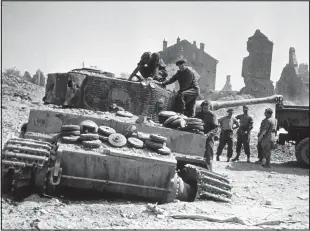  ??  ?? Destroyed: British engineers in the aftermath of the Battle of Villers-Bocage