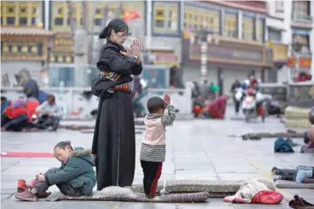  ?? — Reuters ?? This file photo shows Tibetans praying outside Jokhang Monastery ahead of Tibetan New Year’s Day in Lhasa on February 28, 2014.