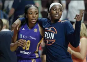  ?? THE ASSOCIATED PRESS ?? In this file photo, sisters Los Angeles Sparks’ Nneka Ogwumike, left, and Connecticu­t Sun’s Chiney Ogwumike, right, walk off the court together at the end of a WNBA basketball game between the their teams, in Uncasville, Conn. Chiney Ogwumike remembers...