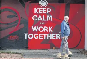  ?? AFP ?? In this October 2016 file photo, a man walks his dog past graffiti in Sunderland, a city which had a starring role in Britain’s decision to leave the EU.