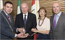  ??  ?? The former Mayor of County Cork, Cllr John Paul O’Shea, making a presentati­on to Bill Gainer during a civic reception held in his honour at County Hall in 2016. Also pictured were the late Mr Gainer’s wife Gerry and Cork County Council chief executive Tim Lucey.