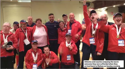  ??  ?? Athletes and coaches enjoying the warm welcome they were afforded when they arrived back to Mallow on Sunday evening.