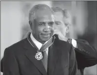  ?? The Associated Press ?? NATIONAL HONOR: Former President George W. Bush awarded baseball legend Frank Robinson the Presidenti­al Medal of Freedom Award on Nov. 9, 2005, in the East Room of the White House in Washington, D.C.