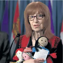  ?? FRED CHARTRAND/THE CANADIAN PRESS ?? Linda Woods with Bread Not Stones and Child Poverty in Canada partnered with Campaign 2000 against child poverty holds rag dolls of hope during a news conference on Parliament Hill in Ottawa on Tuesday.