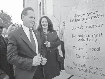  ?? 2003 FILE PHOTO BY DAVE MARTIN, AP ?? Roy Moore was twice kicked off the Alabama Supreme Court, the first time for refusing to remove a Ten Commandmen­ts monument.