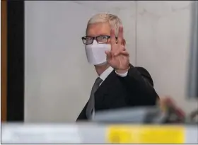 ?? (Bloomberg (WPNS)/David Paul Morris) ?? Tim Cook, chief executive officer of Apple, gestures in May while exiting U.S. district court in Oakland.