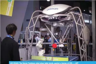  ?? — AFP ?? LAS VEGAS: The Omron Forpheus robot plays table tennis against a human at CES.