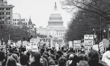  ?? Andrew Caballero-Reynolds / AFP via Getty Images ?? Anti-war activists march from the White House to the Trump Internatio­nal Hotel to protest the killing of Iran’s Maj. Gen. Qassem Soleimani and the decision to send thousands more U.S. troops to the Middle East.