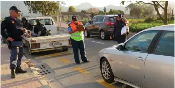  ??  ?? Police assist traffic officers at the roadblocks.