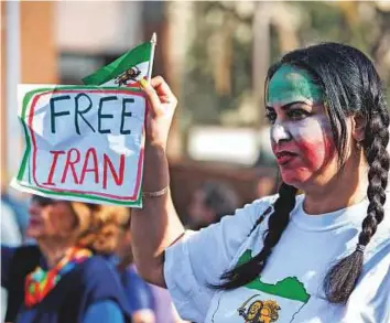  ?? Reuters ?? Setareh Javidan attends a rally in support of Iranian anti-government protests in Los Angeles on Sunday. Around 2,000 protesters chanted in Farsi and English as they marched through neighbourh­oods in west Los Angeles, home to a large Iranian expatriate community.