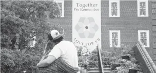  ?? KAITLIN MCKEOWN/STAFF FILE ?? People embrace at a memorial in front of Virginia Beach Municipal Center Building 2 to honor the victims of a May 2019 mass shooting. The buildings are set for a major renovation soon.