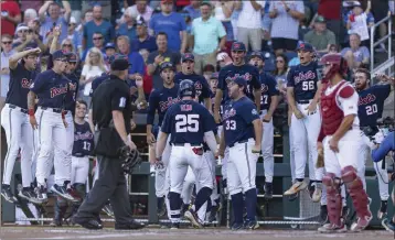  ?? JOHN PETERSON — THE ASSOCIATED PRESS ?? Ole Miss' Tim Elko (25) celebrates his home run with teammates in the third inning of the CWS opener versus Oklahoma.