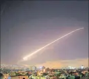  ??  ?? The Damascus sky lights up with missile fire as the US, the UK and France launch an attack on Syrian targets. AP PHOTO