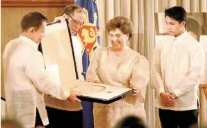  ?? MALACAÑANG PHOTO ?? Actress Susan Roces receives Fernando Poe Jr.’s National Artist award from Felipe de Leon, chairman of the National Commission for Culture and the Arts, and President Benigno Aquino 3rd in Malacañang on Thursday. Beside Roces is her grandson Bryan...