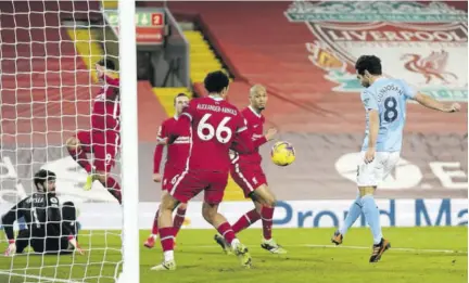  ?? (Photo: AFP) ?? Manchester City’s German midfielder Ilkay Gundogan (right) shoots to score their second goal during the English Premier League football match between Liverpool and Manchester City at Anfield in Liverpool, north-west England, yesterday.