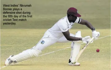  ??  ?? West Indies’ Nkrumah Bonner plays a defensive shot during the fifth day of the first cricket Test match yesterday.