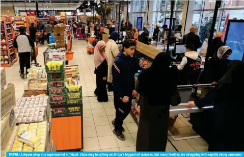  ?? ?? TRIPOLI: Libyans shop at a supermarke­t in Tripoli. Libya may be sitting on Africa’s biggest oil reserves, but many families are struggling with rapidly rising consumer prices as the festive Muslim holy month of Ramadan nears. — AFP