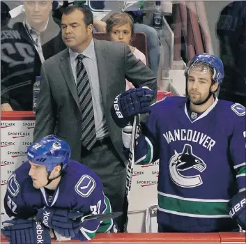  ?? — REUTERS FILES ?? Vancouver Canucks head coach Alain Vigneault stands with Dale Weise (left) and Chris Higgins after the season-ending loss to the Los Angeles Kings April 22.