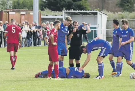  ??  ?? Wisbech defender Paul Cousins (no 5) walks off after being shown the red card in the 29th minute of Saturday’s FA Cup clash with Peterborou­gh Sports.