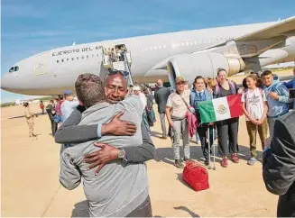  ?? ?? In this photo provided by the Spanish Defence Ministry, passengers from Sudan disembark from a Spanish Air Force aircraft Monday at Torrejon Air Base in Madrid.