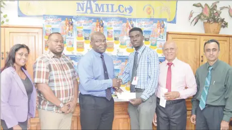  ??  ?? Petra Organizati­on representa­tive Mark Allen (3rd from right) collecting the sponsorshi­p cheque from NAMILCO Financial Controller Fitzroy McLeod (3rd from left) while other members of the presentati­on party including Petra Organizati­on Co-Director Troy...