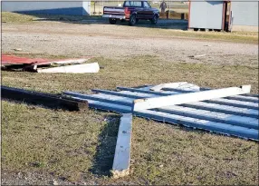  ?? TIMES photograph by Annette Beard ?? Assistant baseball coach Matt Easterling was busy cleaning up the baseball field early Tuesday morning after midnight storms ripped the roof off the dugout and broke the cable that holds the net behind home base.