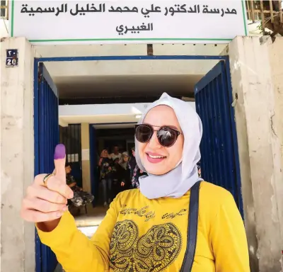  ?? AFP ?? FAST FACT
Some 718 candidates on 103 lists are running for seats in the 128-member parliament. Results are expected on Monday.
A Lebanese woman shows her ink-stained thumb after casting her vote in parliament­ary elections at a polling station in Beirut on Sunday.