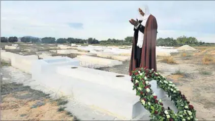  ?? Photo: Fethi Belaid/AFP ?? Desert song: A Tunisian man prays at the mausoleum in Sidi Bouzido of Mohamed Bouazizi, the young fruit seller whose death sparked the Arab Spring revolution­s of North Africa.