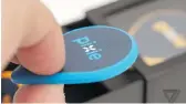  ??  ?? The Pixie, a Bluetooth-enabled fob, attaches to checked baggage and tracks it through an app.