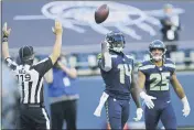  ?? JOHN FROSCHAUER — THE ASSOCIATED PRESS ?? Seattle Seahawks wide receiver DKMetcalf (14) tosses the ball as he stands with running back Travis Homer
(25) after Metcalf scored a touchdown against the Dallas Cowboys during the second half on Sunday, in Seattle.