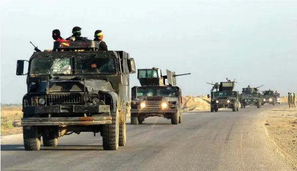  ?? EPA ?? Kataib Hezbollah fighters in Iraq. Sources say the militia is pushing to end an unofficial ceasefire between Tehran-backed groups and US troops in the region