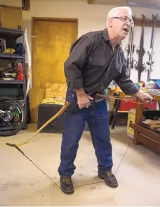  ??  ?? ABOVE: Jim Martin demonstrat­es how to string a bow in his garage at his Tijeras home.