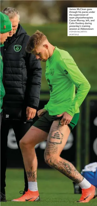  ??  ?? James McClean goes through his paces under the supervisio­n of team physiother­apists Ciaran Murray, left, and Colin Dunlevy during yesterday’s training session at Abbotstown