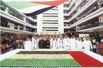  ?? WAM ?? Emirates unveils heritage house Shaikh Ahmad Bin Saeed Al Maktoum at the purpose-built heritage house draped in the colours of the UAE flag that was unveiled at the atrium of Emirates group headquarte­rs yesterday. He also attended a cake-cutting...