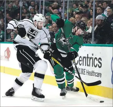  ?? Ronald Martinez Getty Images ?? DEREK FORBORT of the Kings, left, tries to take the puck away from Radek Faksa of the Dallas Stars.