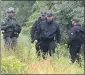  ?? MICHAEL DWYER THE ASSOCIATED PRESS ?? Police gather near the site of a standoff with a group of armed men Saturday in Wakefield, Mass.