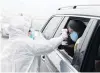  ?? PHOTO: REUTERS ?? A medical worker checks the body temperatur­e of a passenger at a checkpoint outside the city of Yueyang, Hunan province, in China.