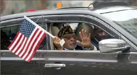  ??  ?? David Lanier, with American Legion Post 527 in Rankin and driven by Ken Poston, waves to spectators along the parade route.