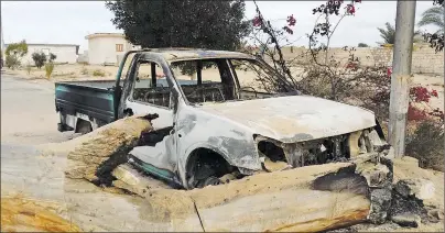  ?? AP PHOTO ?? A burned truck is seen outside Al-Rawda Mosque in Bir al-Abd northern Sinai, Egypt a day after attackers killed hundreds of worshipper­s, on Saturday.