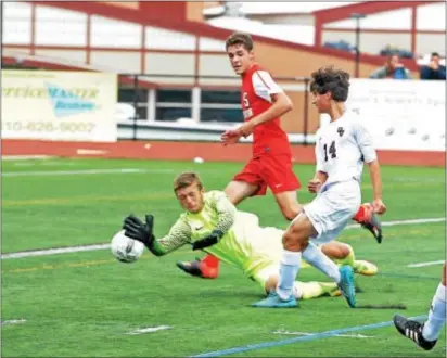  ?? ROB DUDLEY — FOR DIGITAL FIRST MEDIA ?? Nat Orminsky (14) pokes home a rebound to open the scoring in Garnet Valley’s 2-1 victory over Souderton.