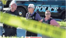  ?? JOSE LUIS MAGANA/AP ?? Police officers secure the area after multiple people were shot Thursday at the Capital Gazette in Annapolis, Maryland.