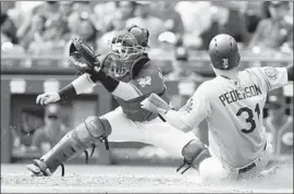  ?? John Minchillo Associated Press ?? JOC PEDERSON barely beats a throw to Cincinnati Reds catcher Tucker Barnhart to score in the top of the fifth inning of the Dodgers’ 8-1 victory.