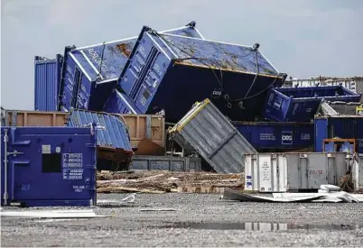  ?? Luke Sharrett / Bloomberg ?? Offshore oil supply containers are strewn about after Hurricane Ida’s storm surge swept through Port Fourchon, La., on Aug. 31. Ida did more damage to production than February’s freeze.